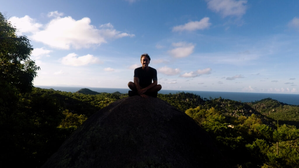 Yentl sitting on a rock on Magnetic Island - blue skies