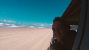 Hanging out of a car on the beach in Fraser Island