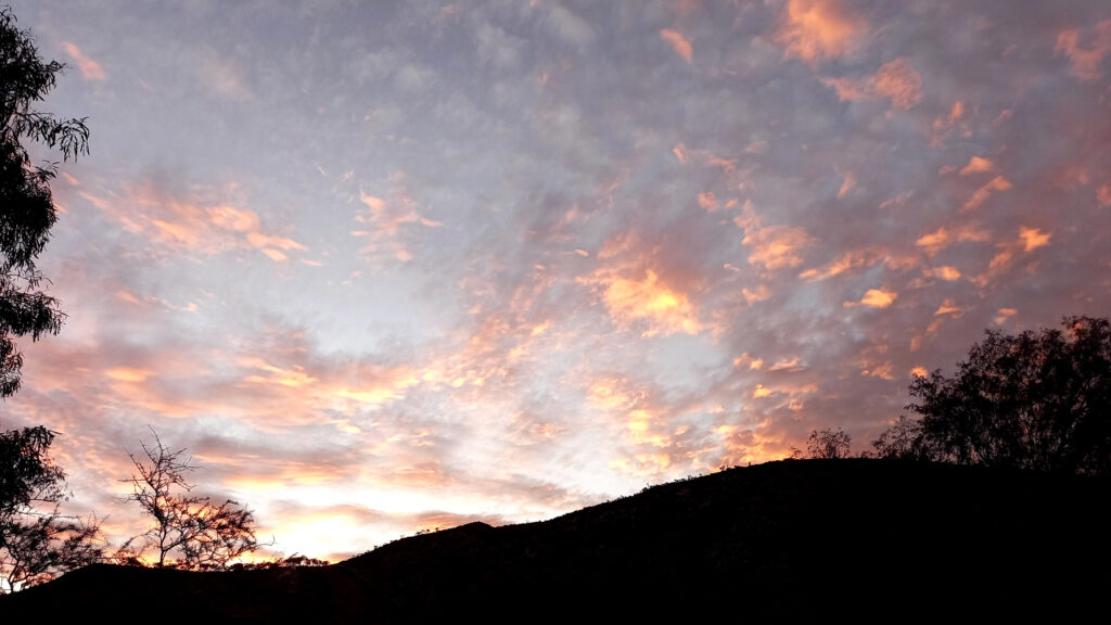 the sun over mountains at Ellery Creek campsite