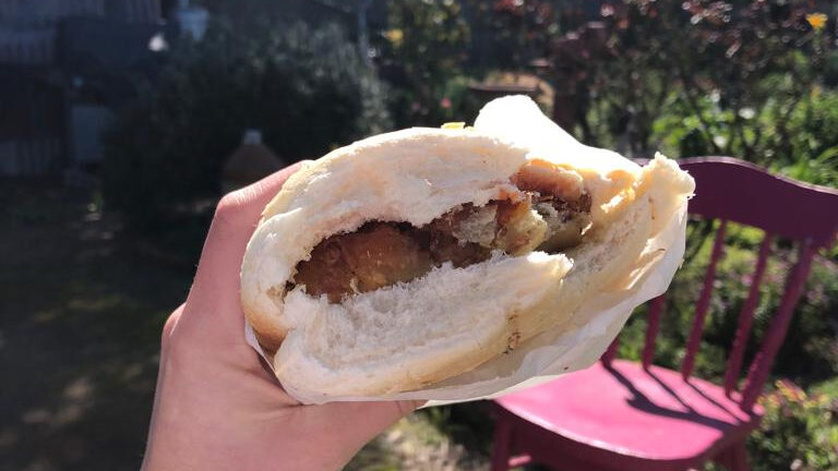 a savoury slice in a flat bun from the McCue’s Bakery.