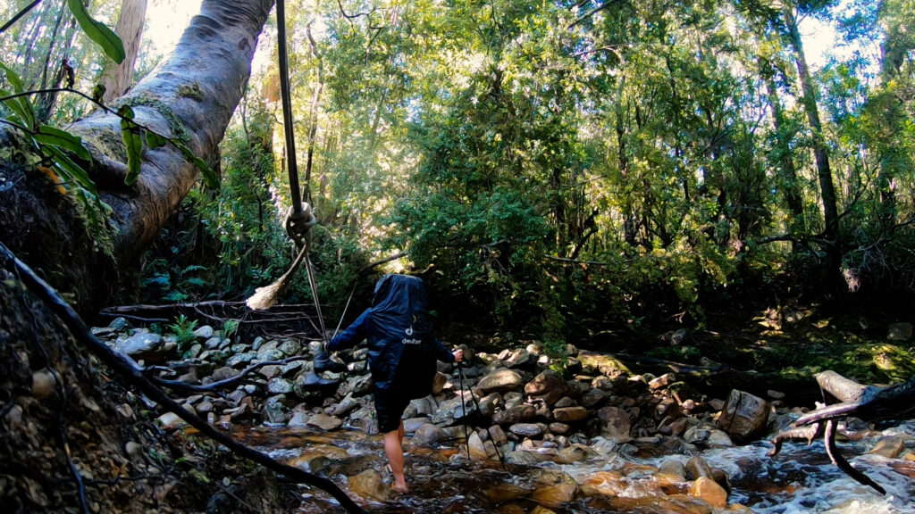 Picture of Yentl Doggen crossing rivers on the South Coast Track