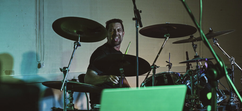 A picture of Daniel Bear playing the drums 